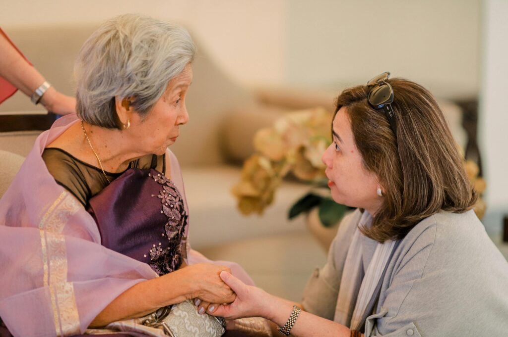 pexels photo 36578169 36578169 Heartwarming interaction between a senior woman and her adult daughter indoors.