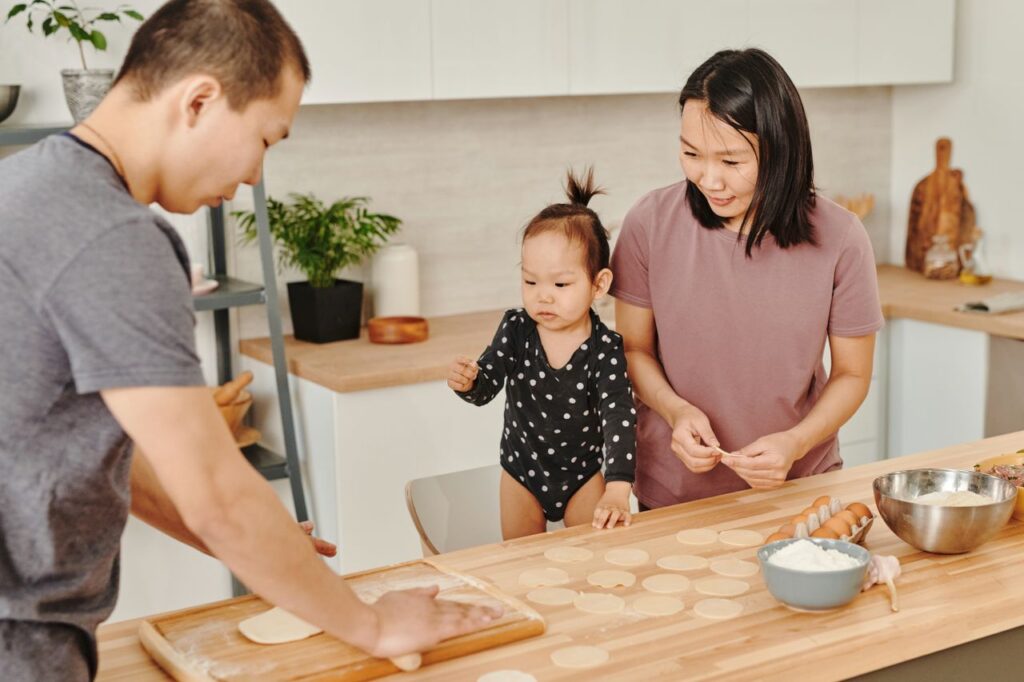 pexels photo 7705374 7705374 Asian family enjoys togetherness making dumplings at home in a cozy kitchen.